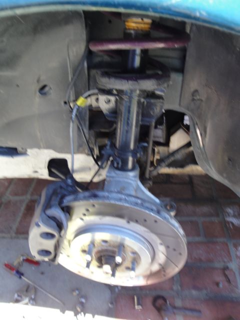 1995 Ford Taurus - Close-up of a vehicle's front wheel assembly, showing the brake rotor, caliper, and suspension components.