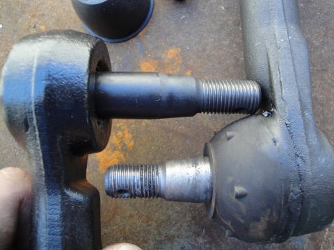 1995 Ford Taurus - Comparison of two tie rod ends, likely for automotive repair or replacement.