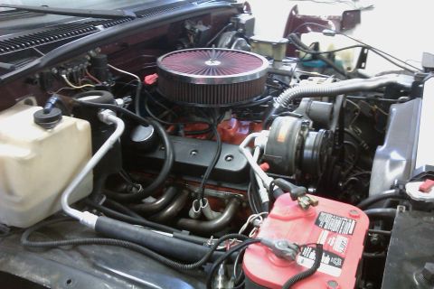 1994 Chevrolet Blazer - Engine bay detail with V8 engine components and Supermotors.net branding.