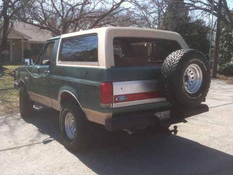 1989 Ford Bronco - This Ford Bronco has a two-tone paint scheme and a spare tire on the back.