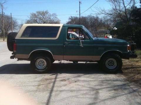 1989 Ford Bronco - This 1987 Ford Bronco is shown in a side profile, a two-tone paint scheme and a rear-mounted spare tire.