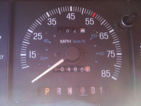 1989 Ford Bronco - The vehicle's dashboard displays the speedometer, odometer reading, and gear selection indicator.