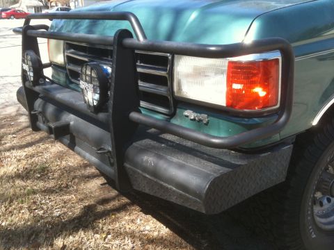 1989 Ford Bronco - This SUV features a heavy-duty bull bar and auxiliary lights, along with a '4x4' badge on the fender.