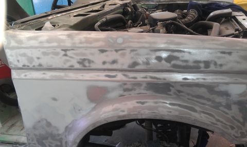 1995 Ford Bronco - Fender repair in progress, with engine visible under the hood.