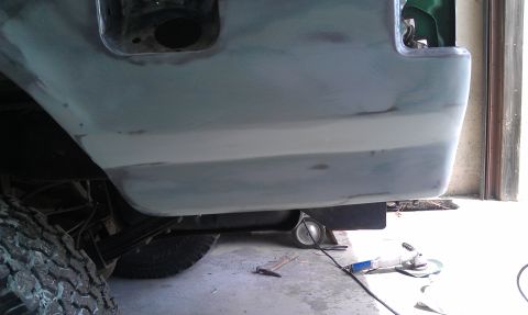 1995 Ford Bronco - Vehicle bodywork undergoing repair, with body filler visible on the rear quarter panel.