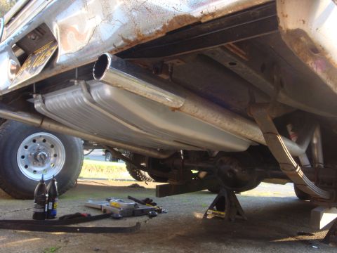 1964 Ford Fairlane - Close-up view of the undercarriage, focusing on the fuel tank and exhaust pipes.
