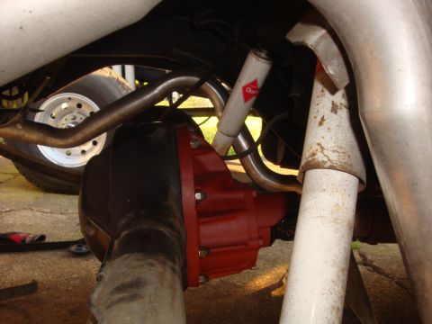 1964 Ford Fairlane - Rear axle and suspension components, including exhaust and shocks, are visible in this close-up shot.