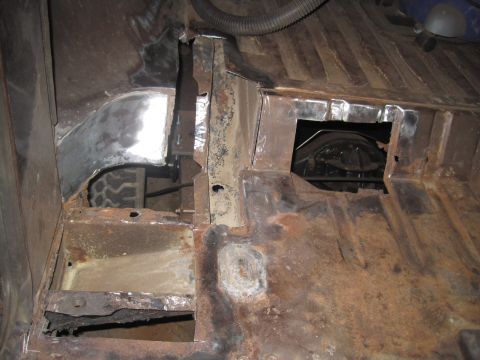 1979 Ford Bronco - This photo shows extensive rust and repair work on the floor pan of a vehicle.