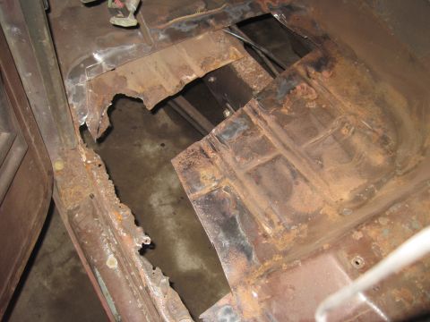 1979 Ford Bronco - Extensive rust damage is visible on the vehicle's floor pan, indicating significant deterioration.