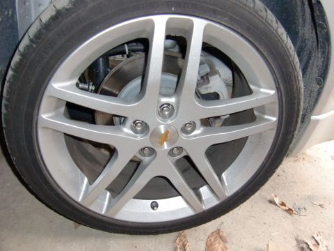2009 Chevrolet Cobalt - Close-up of a silver 5-spoke wheel with a Chevrolet emblem.