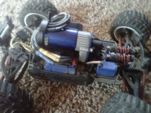 2011 Ford 427 - Close-up view of a remote control car's chassis, highlighting the blue motor and suspension components.