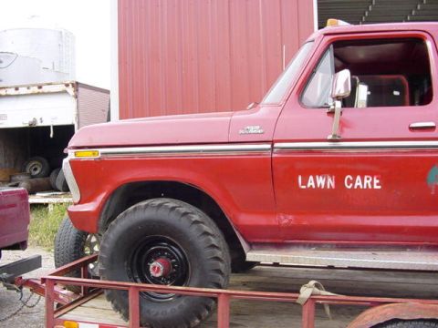 1992 Ford Bronco - A red Ford pickup truck, likely from the 1970s, is shown from the side while on a trailer.