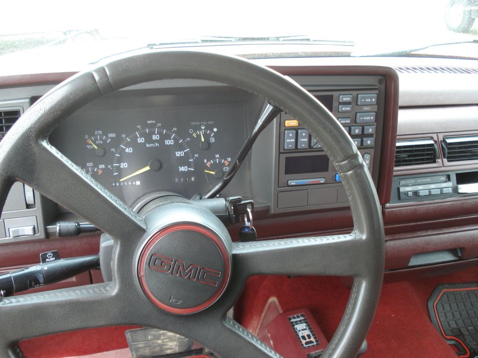GMC pickup dash and gauge cluster with diesel fuel label and red carpet