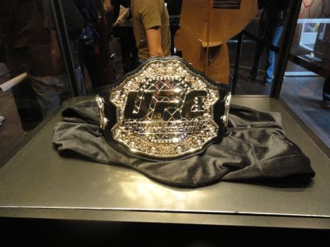 1996 Ford Bronco - A championship belt with the UFC logo is displayed on a dark cloth inside a glass case.