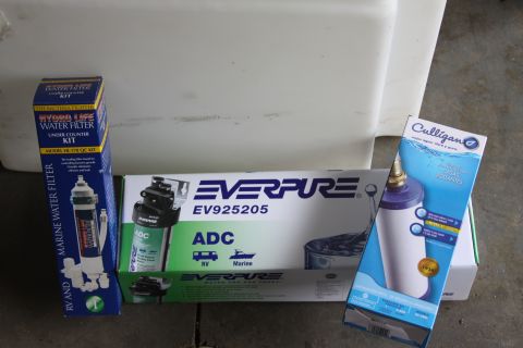 2003 Ford F-350 - Various water filter packaging is displayed, including Hydro Life, Everpure, and Culligan brands.