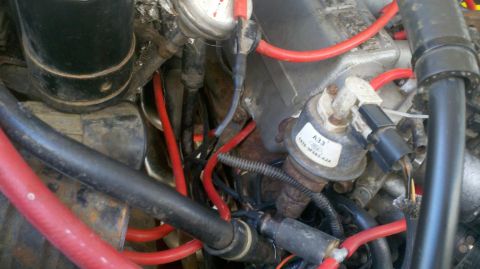 1989 Ford Bronco - Engine bay detail showing various parts and wiring, with a visible part number label.