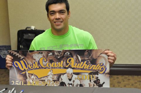 1996 Ford Bronco - Man holds a promotional sign for West Coast Authentic various sports imagery and contact information.