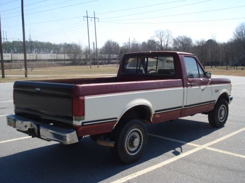 1989 Ford F-250 - This Ford F-250 pickup truck has a two-tone paint scheme with maroon and white sections.