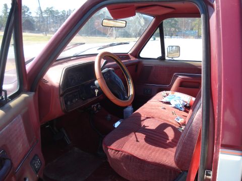 1989 Ford F-250 - Interior view of a red pickup truck, likely from the late 1980s.