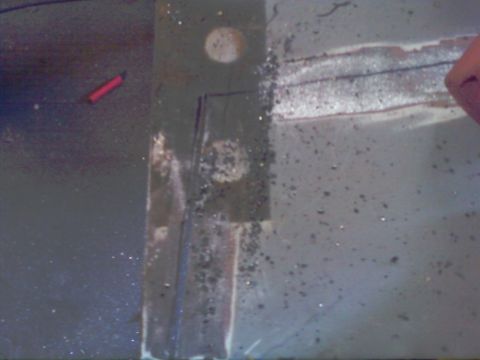 1989 Ford Bronco - Metal surface shows debris and tool marks, possibly from fabrication or repair work.