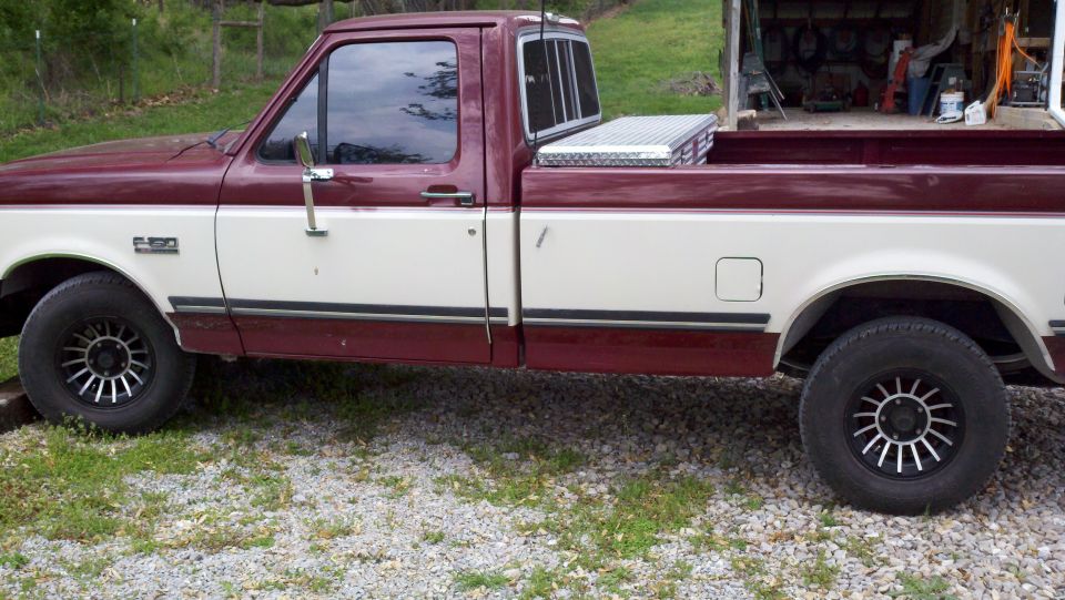 1989 Ford F-150 pickup truck, two-tone maroon and white, with a toolbox in the bed
