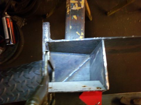 1989 Ford Bronco - Close-up view of a fabricated metal bracket, showing welds and a diamond plate texture.