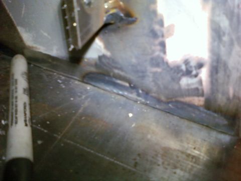 1989 Ford Bronco - A white marker is positioned next to a metal panel showing signs of welding.
