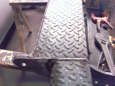 1989 Ford Bronco - A close-up view of a metal fabrication project in progress, showing diamond plate and tools.