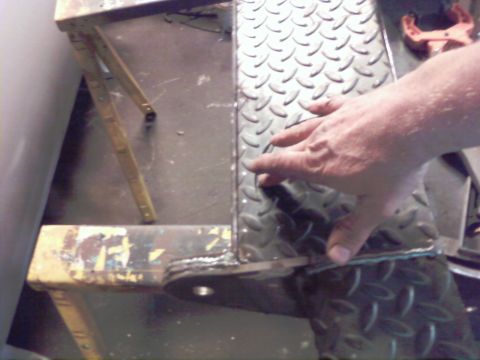 1989 Ford Bronco - A hand is shown on a metal stair with diamond plate texture.