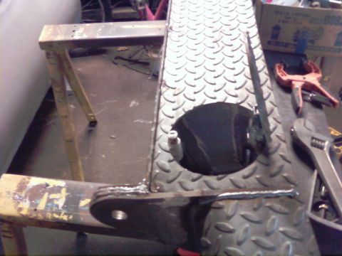 1989 Ford Bronco - A metal component with a diamond plate texture and a circular cutout is shown on a sawhorse.