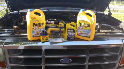 1994 Ford Bronco - Cooling system maintenance supplies are laid out on the hood of a Ford Bronco.