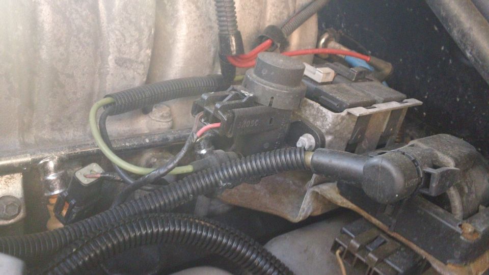 Engine electrical component with black and green wires