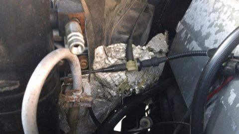 1994 Ford Bronco - Close-up of AC lines and sensor connectors in an engine bay, with insulation visible.
