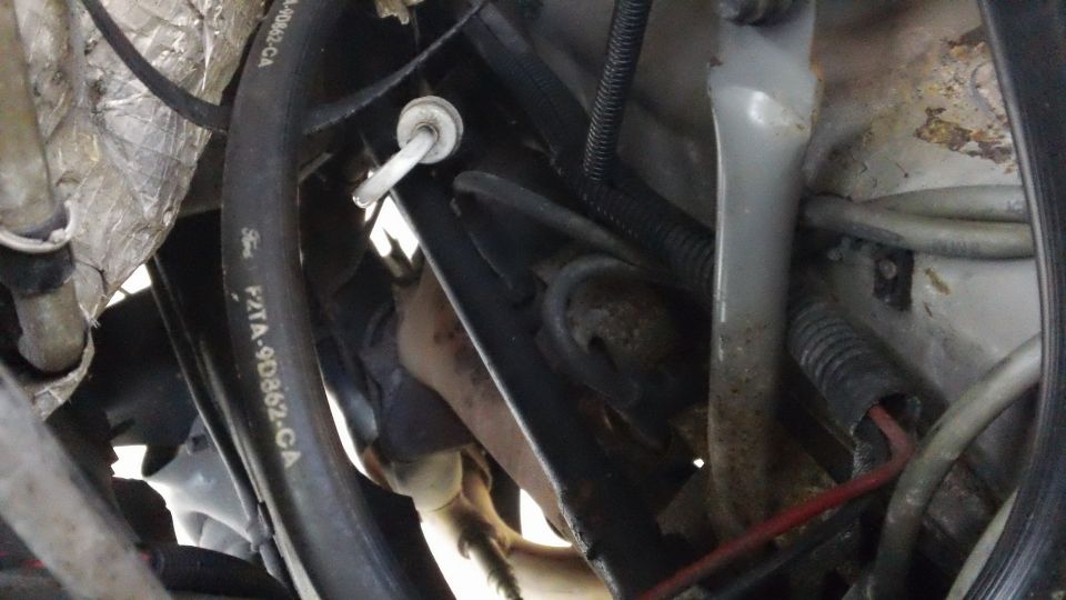 Engine bay with Ford hose labeled F2TA-9D862-CA, showing engine components and wiring