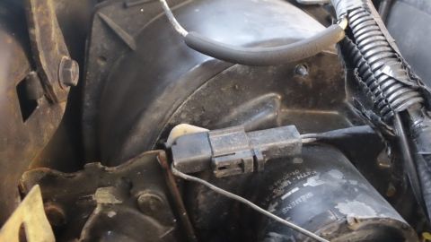 1994 Ford Bronco - Close-up of an engine bay component showing an electrical connector and part number F4TH-18B05.