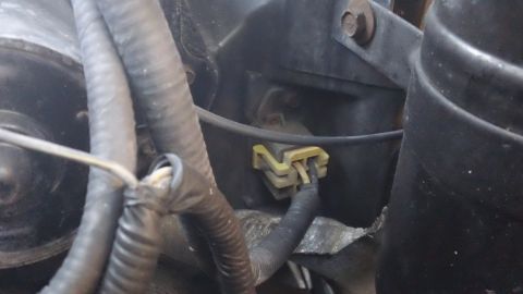 1994 Ford Bronco - A yellow electrical connector and wiring are visible in the engine compartment.