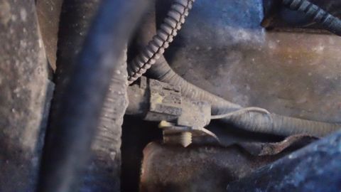 1994 Ford Bronco - Close-up view of an engine component with a connector and wiring, indicating wear and age.