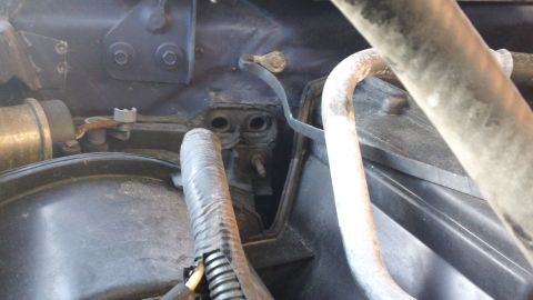1994 Ford Bronco - Close-up view of engine bay components, likely part of the cooling system, with visible hoses and connectors.