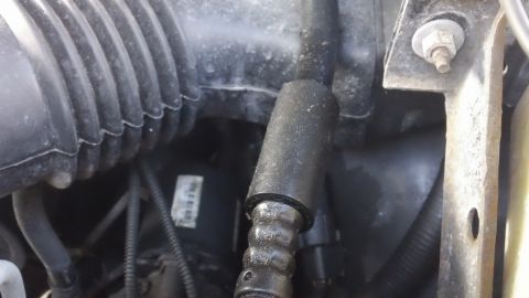 1994 Ford Bronco - This image shows a section of the engine bay with various hoses and the air intake system visible.