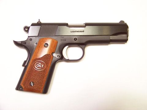 1995 Mercury Grand Marquis - Colt 1911 pistol with wood grips and 'LIGHTWEIGHT' marking on the slide.