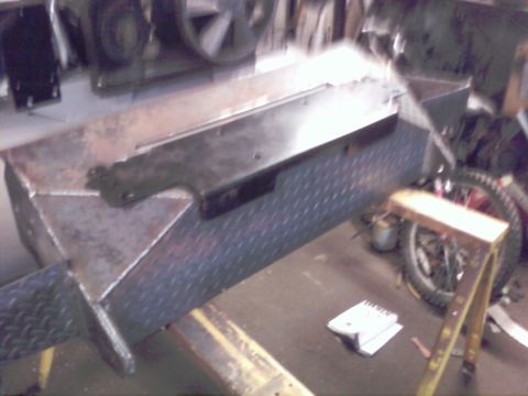 1989 Ford Bronco - A metal box with diamond plate siding and a hinge is visible in a workshop setting.