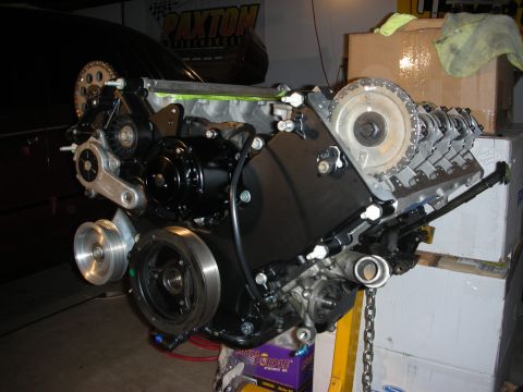 1992 Ford Crown Victoria - Engine assembly with black painted components and silver pulleys is shown in a workshop setting.