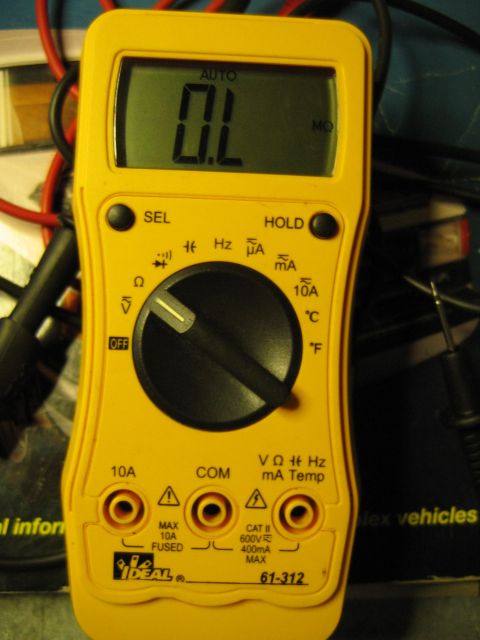 1992 Ford Bronco - A yellow multimeter is shown with its digital display reading OL, indicating an open circuit.