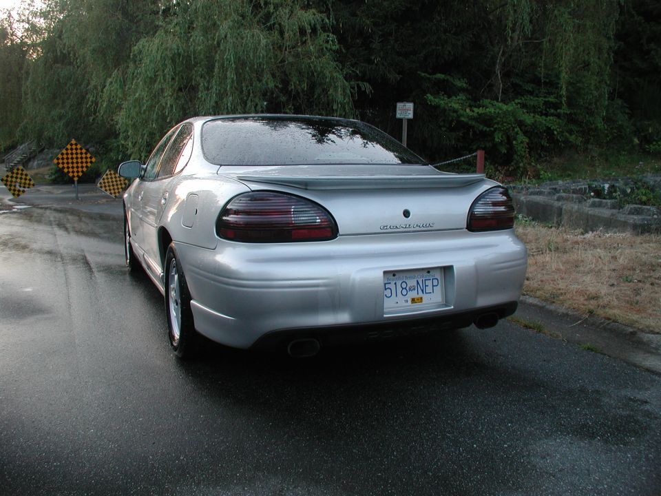 Silver Pontiac Grand Prix GT sedan rear 3/4 view with spoiler, smoked tail lights and BC plate