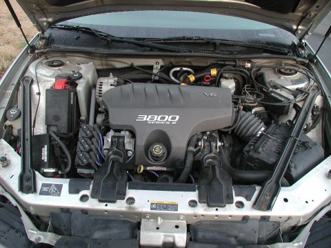 2002 Pontiac Grand Prix - The engine bay of a car, a 3800 Series II V6 engine cover and various engine components.