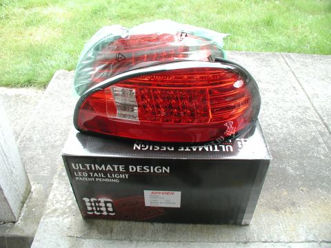 2002 Pontiac Grand Prix - Two red LED tail lights are shown packaged on top of their product box.