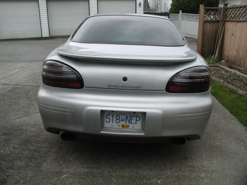 2002 Pontiac Grand Prix - Rear view of a silver 2002 Pontiac Grand Prix, showing its distinctive tail lights and spoiler.