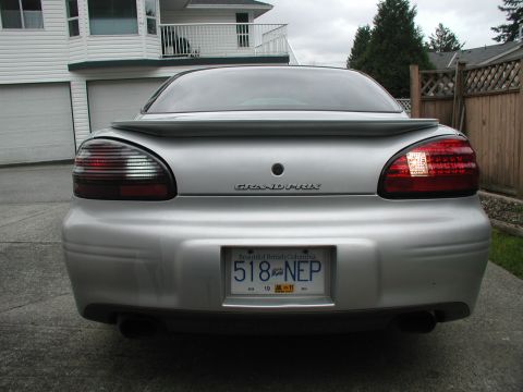 2002 Pontiac Grand Prix - Rear view of a silver 2002 Pontiac Grand Prix, showing its distinctive tail lights and spoiler.