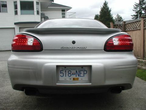 2002 Pontiac Grand Prix - The rear of a silver 2002 Pontiac Grand Prix is shown, its distinctive taillights and spoiler.