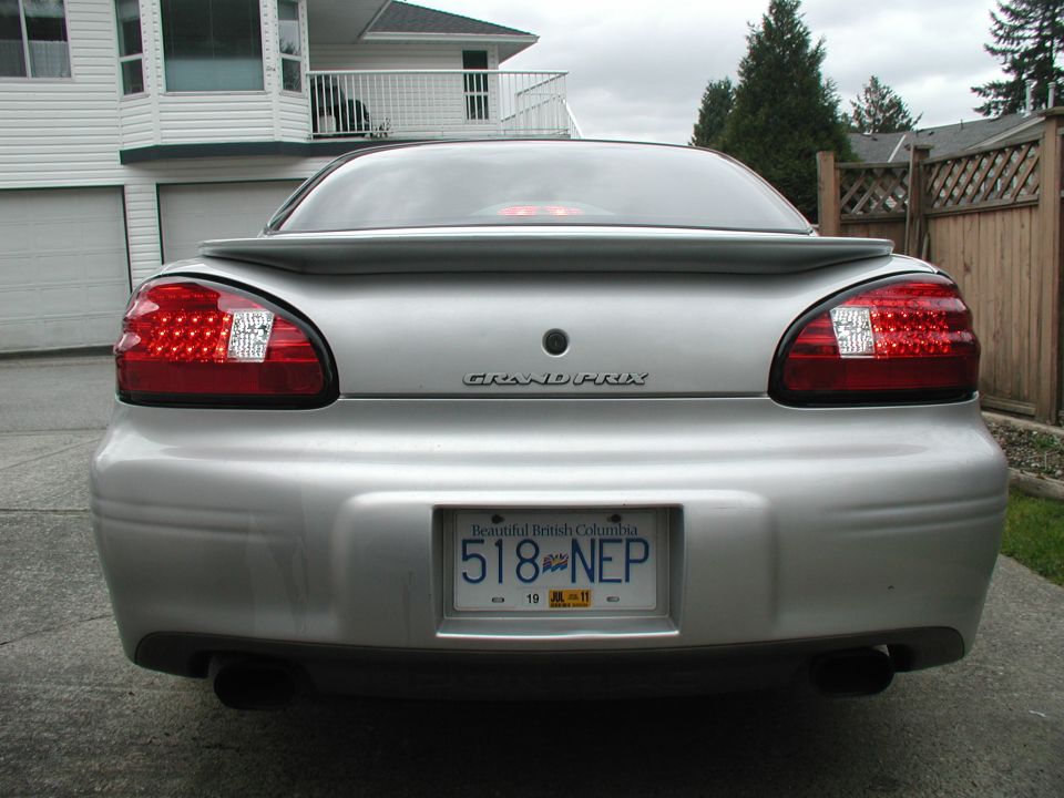 Silver 2002 Pontiac Grand Prix rear view with spoiler and LED tail lights